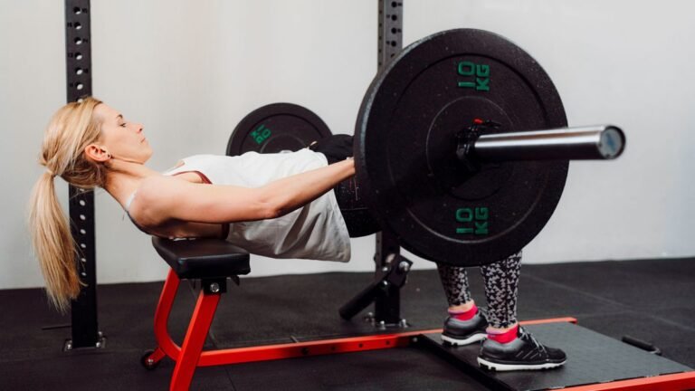 Woman performs hip thrust in gym