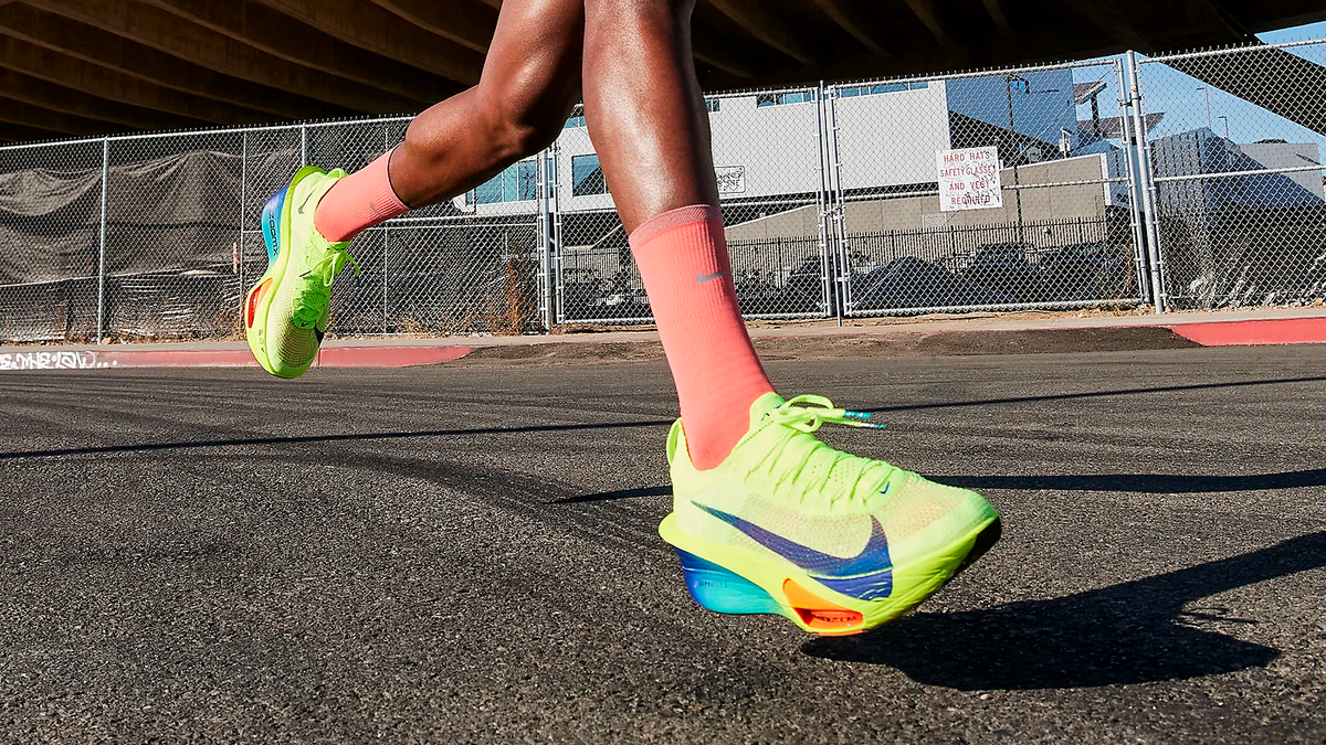 Nike Alphafly 3 running shoes in yellow Volt colorway on feet of runner